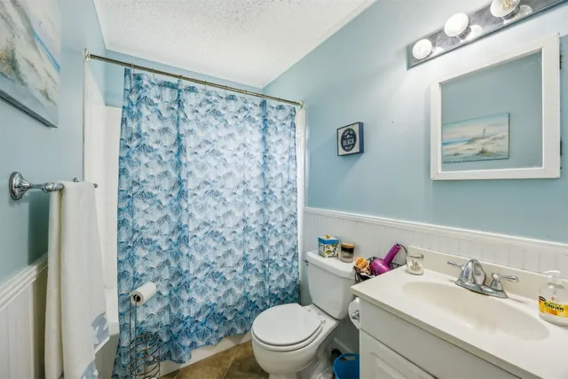 a bathroom with a sink toilet and a mirror