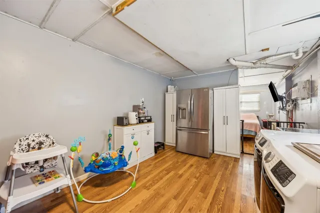 a kitchen with stainless steel appliances kitchen island granite countertop a sink stove and refrigerator
