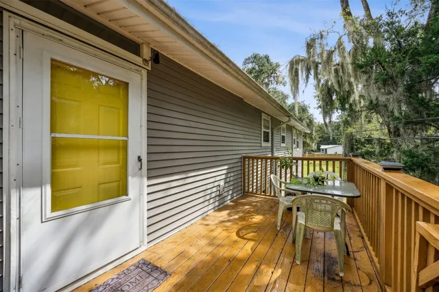a view of balcony with wooden floor and fence