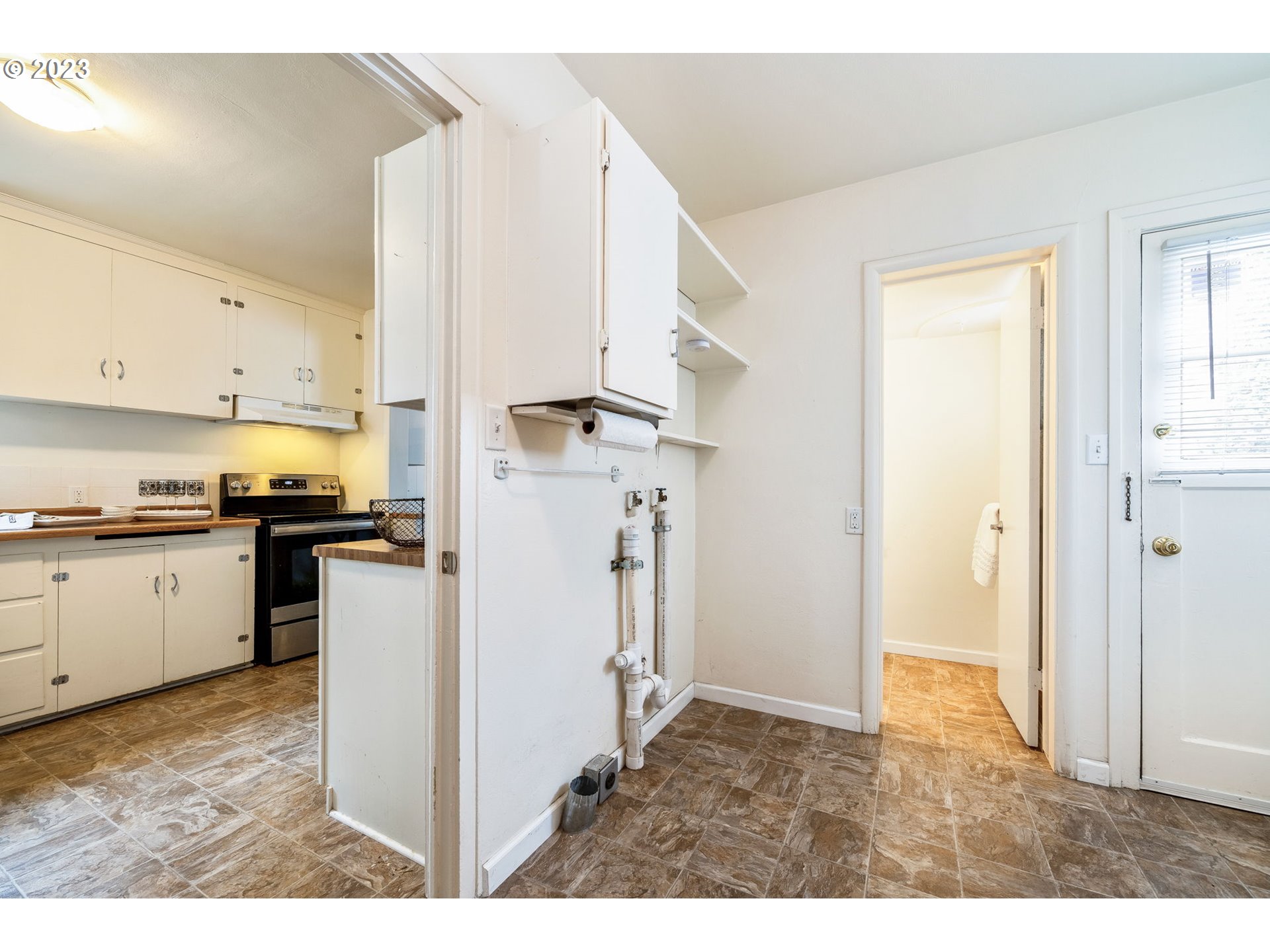 1335 B Street Springfield, OR 97477 - Photo 24 of 40 a kitchen with cabinets and a refrigerator