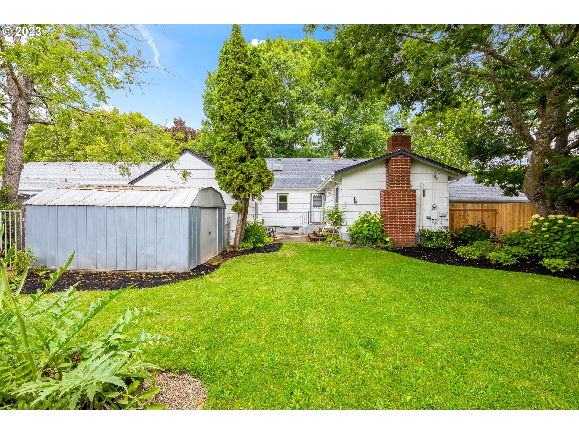 1335 B Street Springfield, OR 97477 - Photo 33 of 40 a view of a backyard with a garden