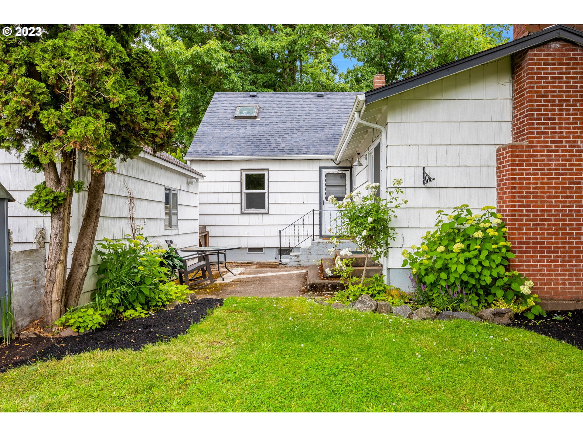 1335 B Street Springfield, OR 97477 - Photo 38 of 40 a view of backyard of house with outdoor seating and green space