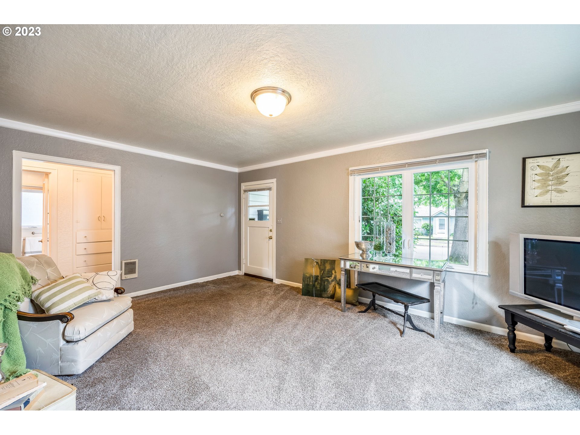1335 B Street Springfield, OR 97477 - Photo 5 of 40 a living room with furniture a window and a flat screen tv