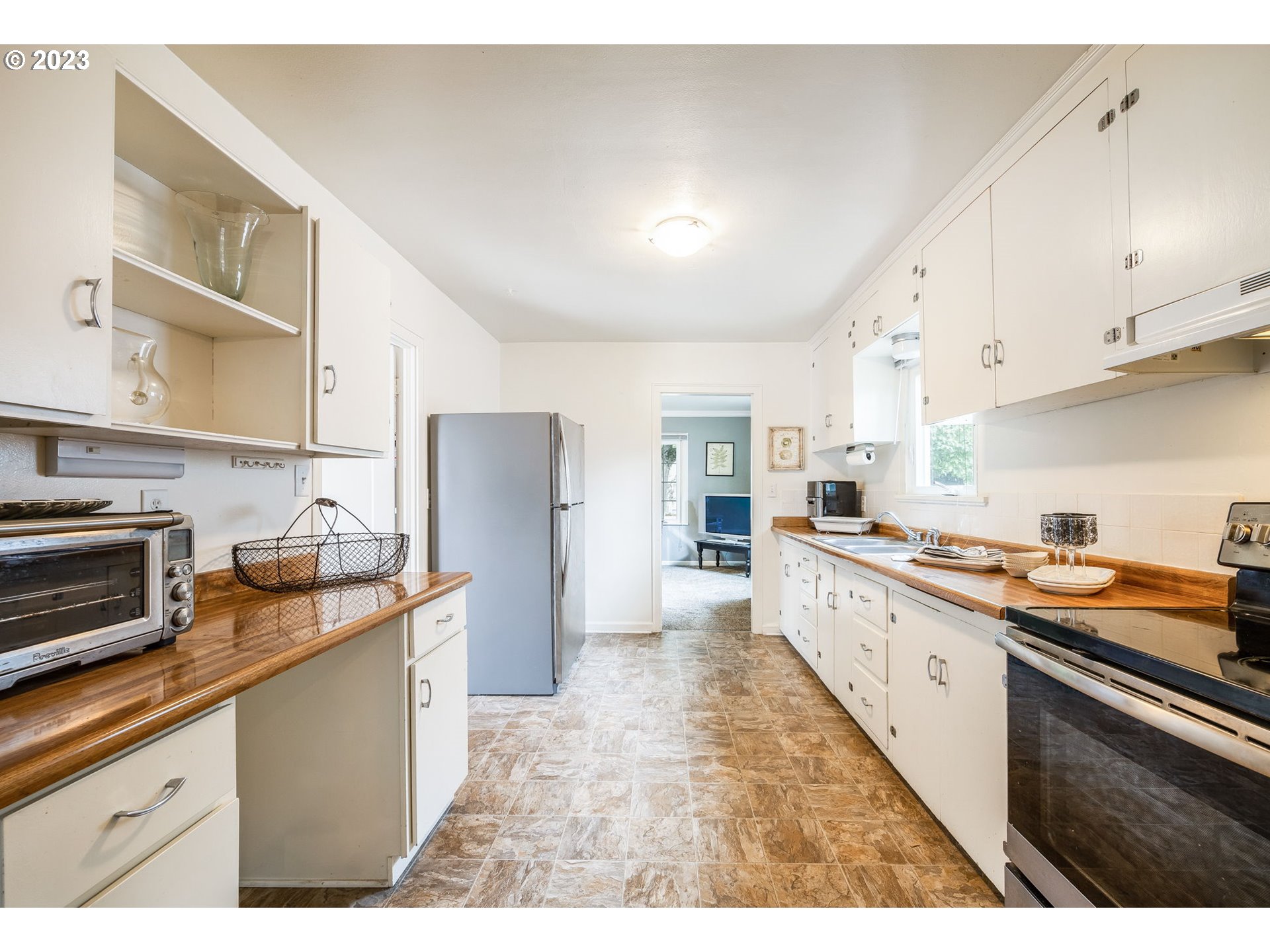 1335 B Street Springfield, OR 97477 - Photo 6 of 40 a kitchen with granite countertop a sink stove and refrigerator