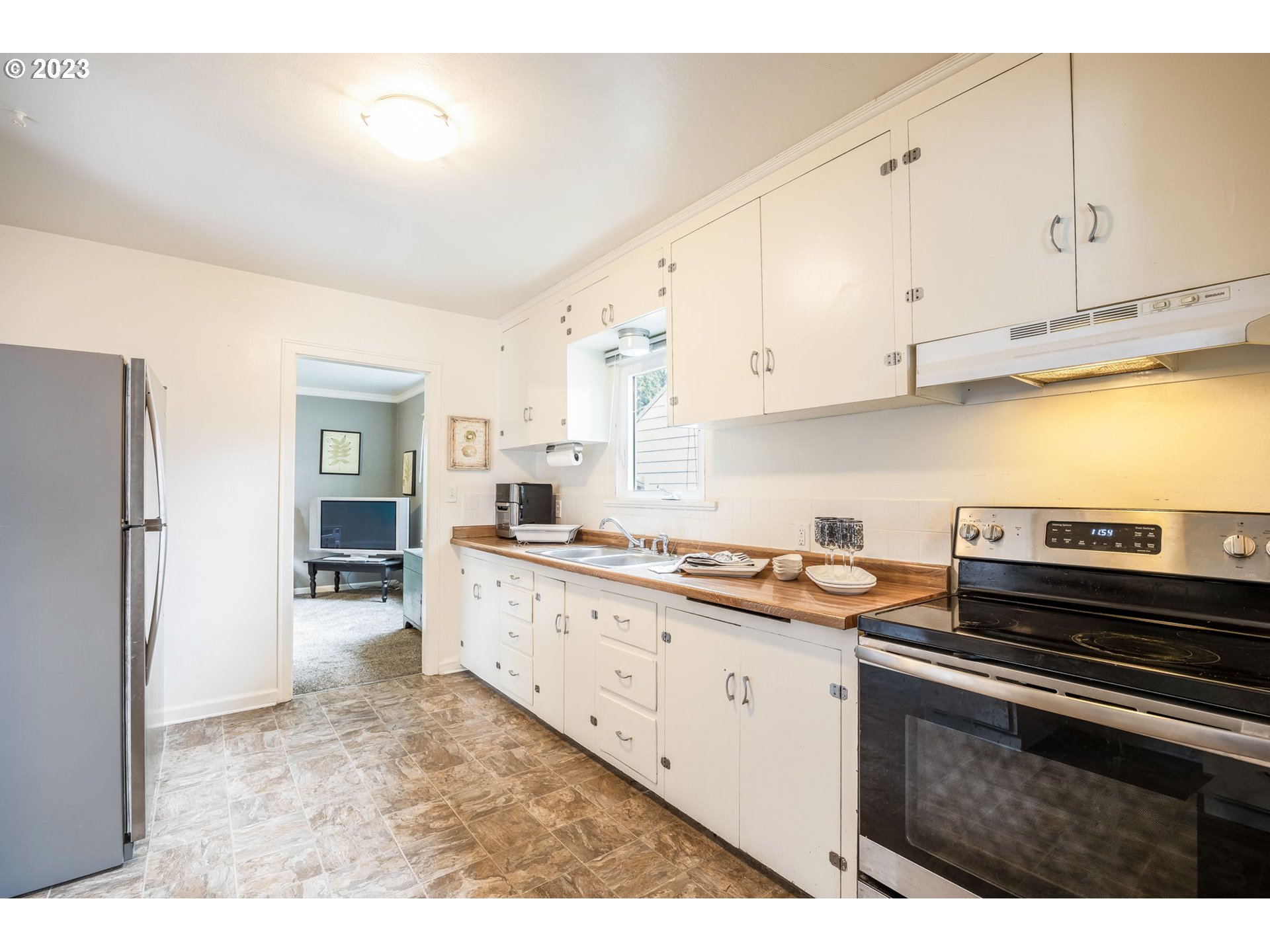 1335 B Street Springfield, OR 97477 - Photo 7 of 40 a kitchen with stainless steel appliances granite countertop a stove a sink and a refrigerator