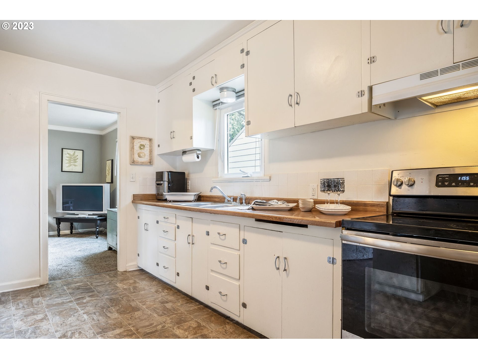1335 B Street Springfield, OR 97477 - Photo 8 of 40 a kitchen with granite countertop a sink a stove and cabinets