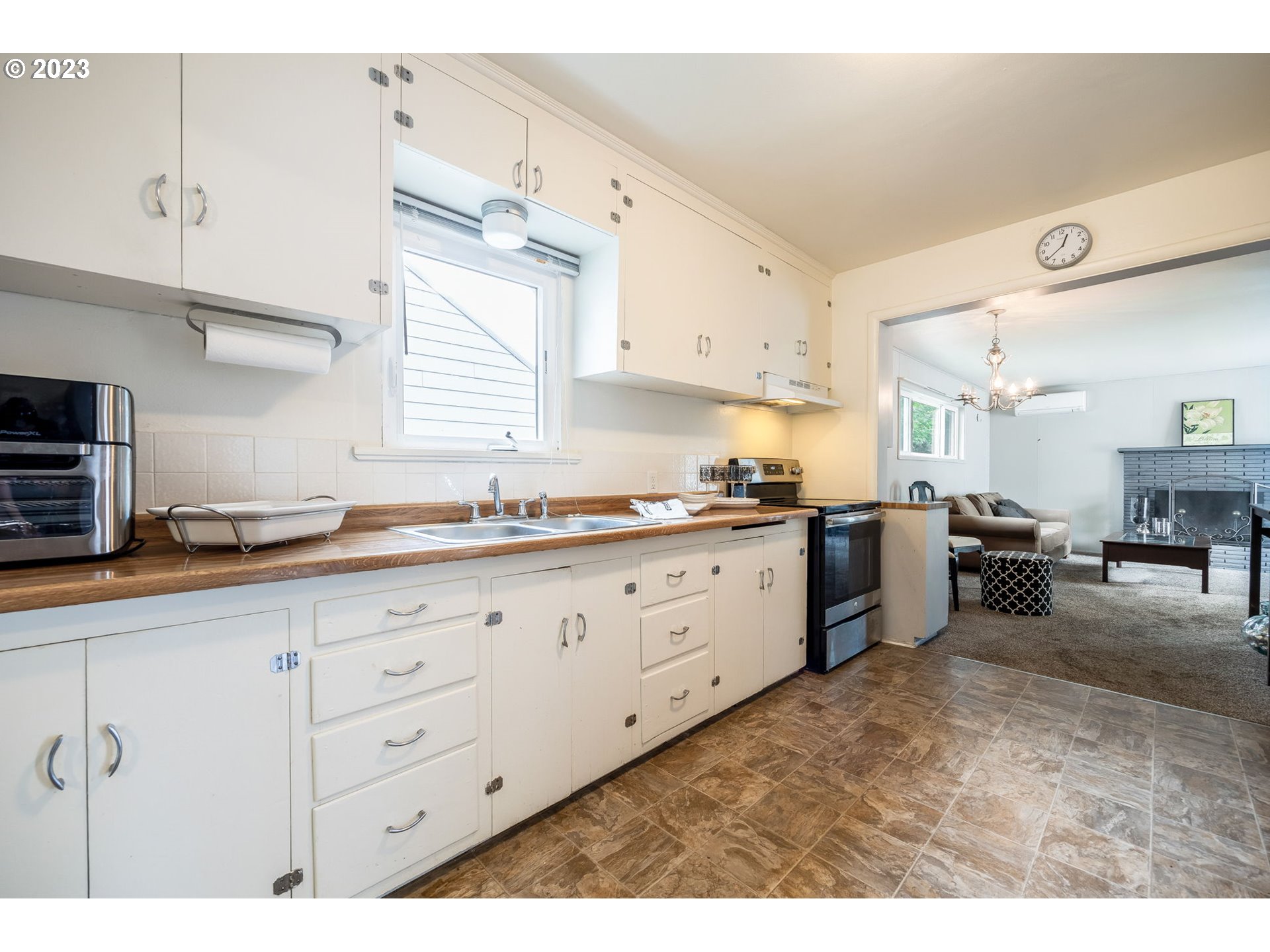 1335 B Street Springfield, OR 97477 - Photo 10 of 40 a kitchen with sink cabinets and window