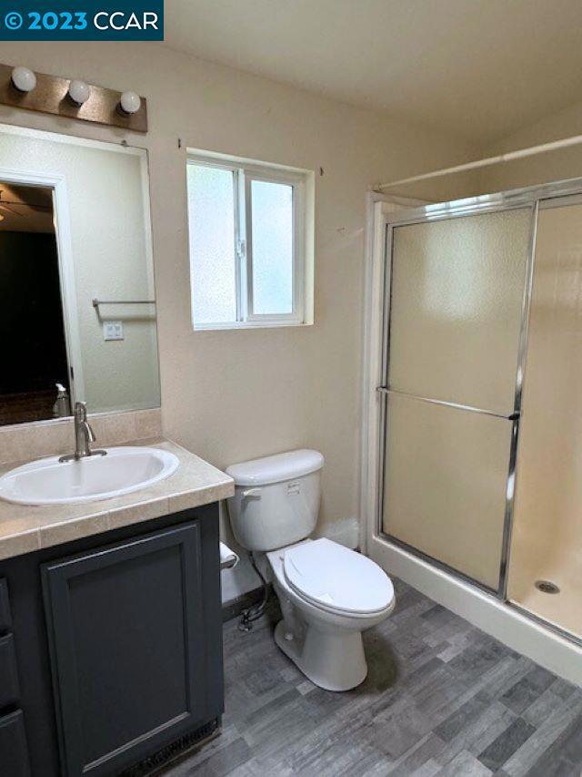 343 San Marcus Drive Vallejo, CA 94590 - Photo 12 of 20 a bathroom with a toilet a sink and a mirror