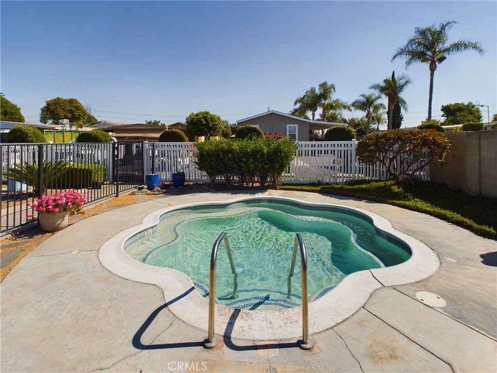 16600 Orange Avenue, Unit 55 Paramount, CA 90723 - Photo 16 of 18 a swimming pool with outdoor seating and yard
