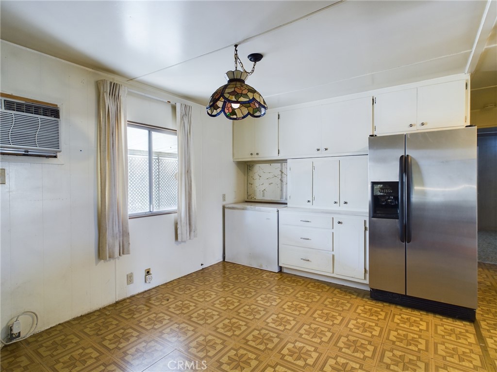 16600 Orange Avenue, Unit 55 Paramount, CA 90723 - Photo 9 of 18 a kitchen with white cabinets and stainless steel appliances