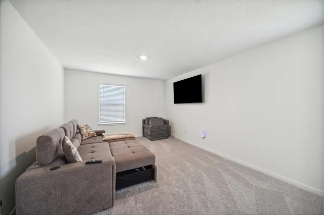 a bedroom with furniture and a flat screen tv