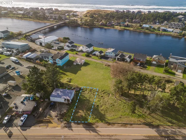 an aerial view of residential houses with outdoor space and river