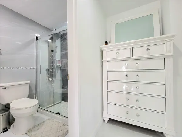 a bathroom with a shower a toilet and a sink