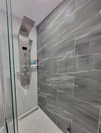 a bathroom with a glass shower door