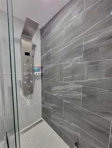 a bathroom with a glass shower door