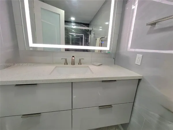 a bathroom with a sink and a mirror