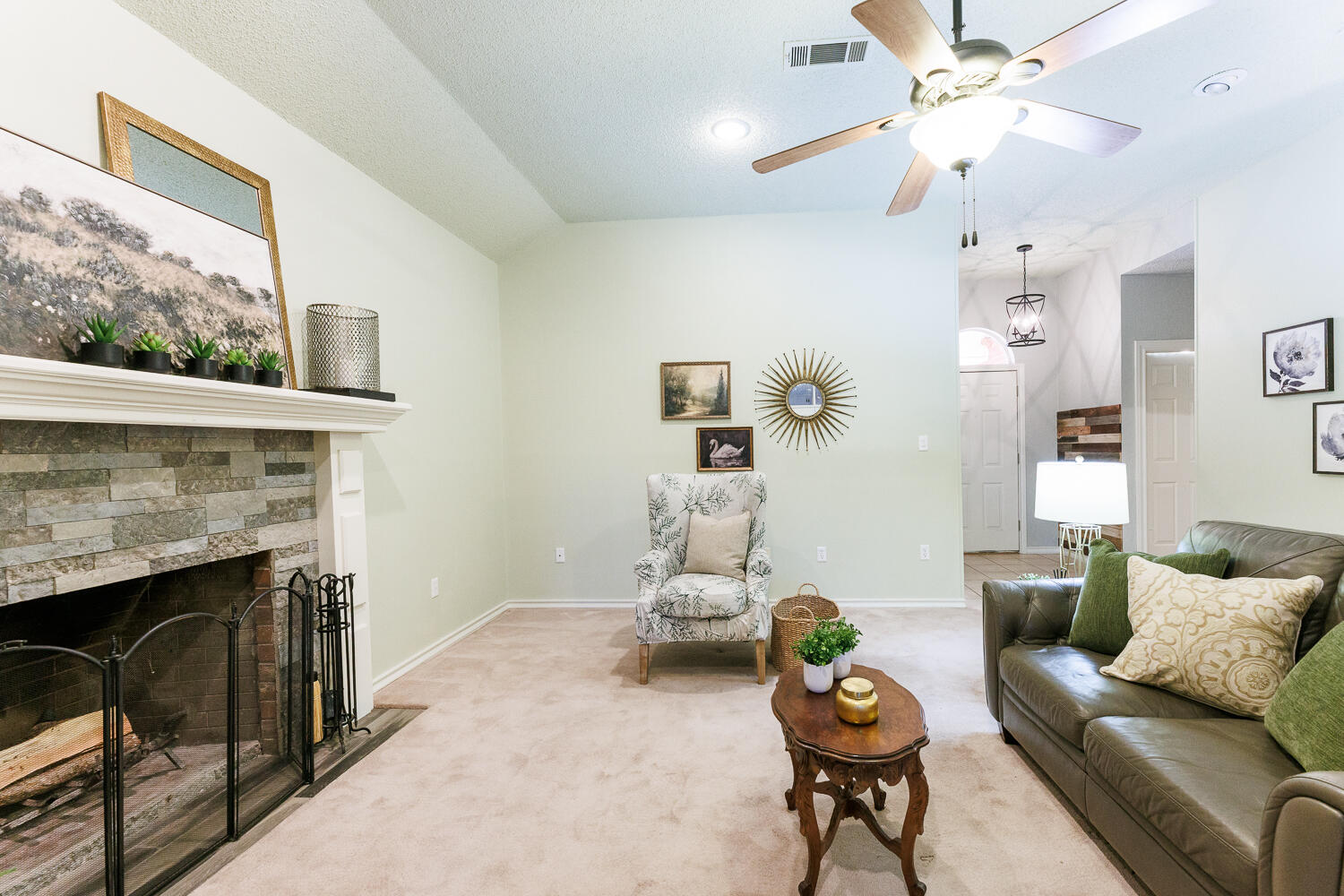 206 Collins Avenue Sundown, TX 79372 - Photo 11 of 82 a living room with furniture a chandelier and a fireplace