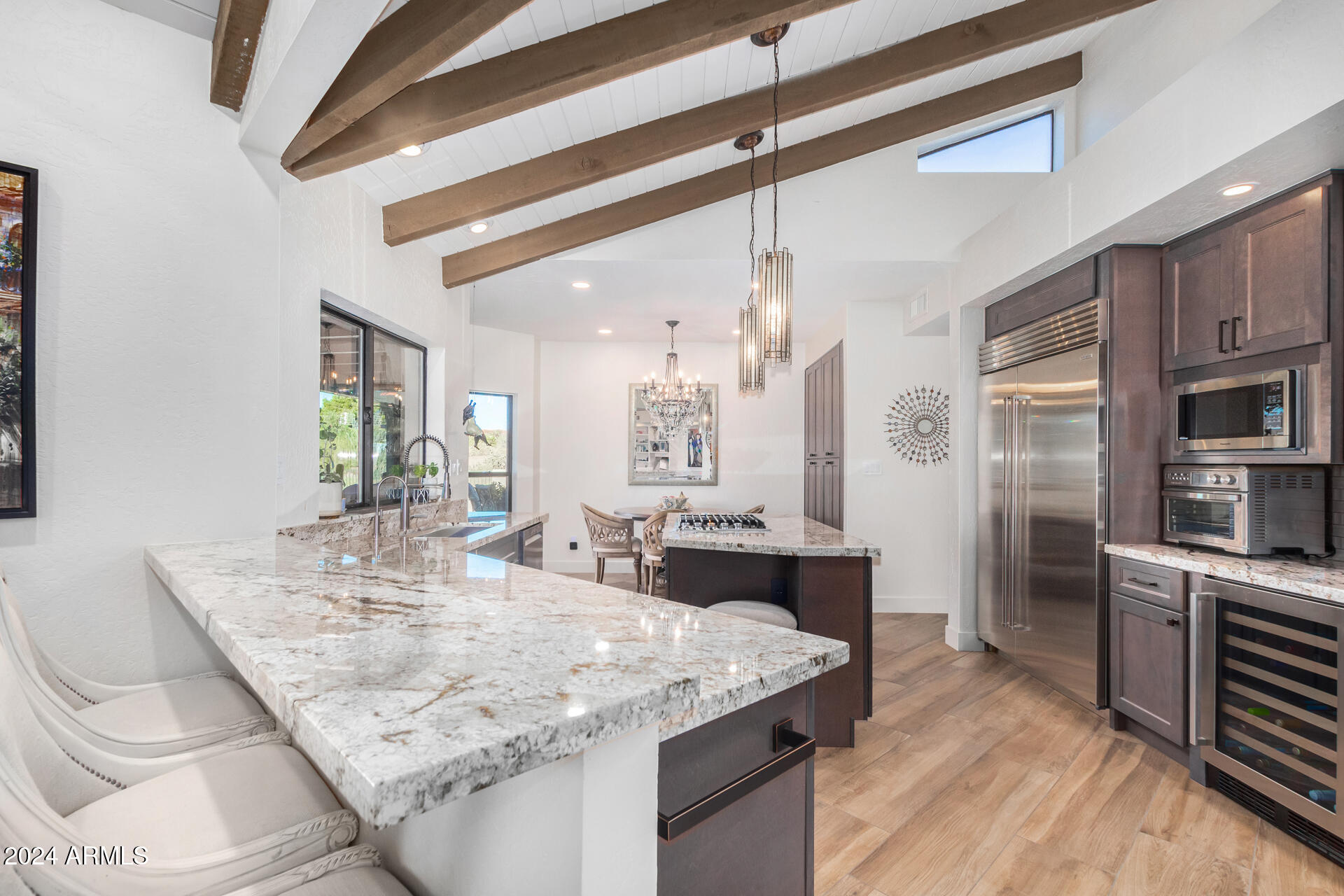 9446 Romping Road Carefree, AZ 85377 - Photo 35 of 119 a dining hall with stainless steel appliances granite countertop a stove and refrigerator
