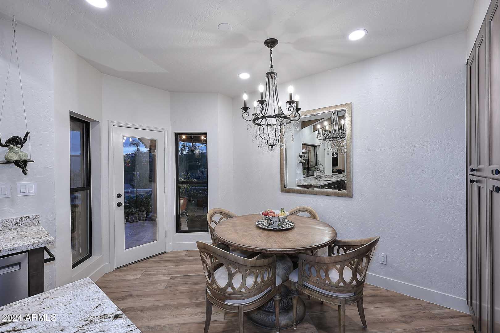 9446 Romping Road Carefree, AZ 85377 - Photo 37 of 119 a view of a dining room with furniture and chandelier