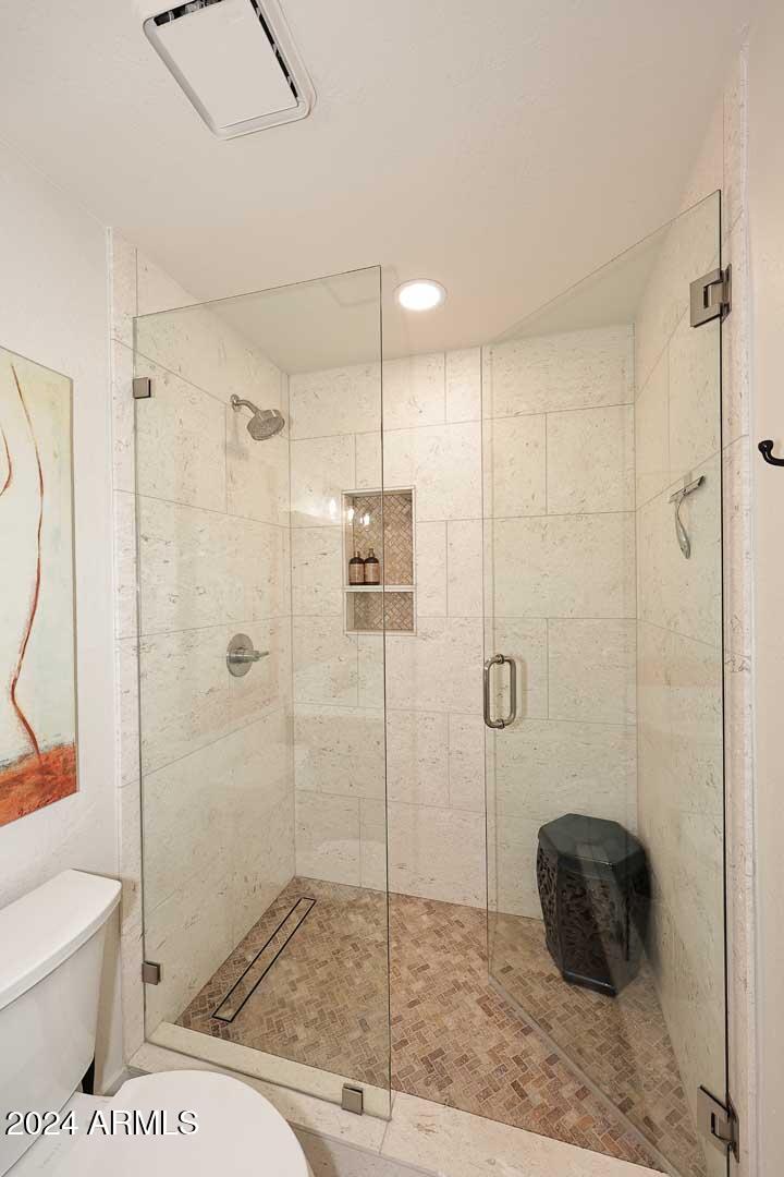 9446 Romping Road Carefree, AZ 85377 - Photo 62 of 119 a bathroom with a toilet and a shower