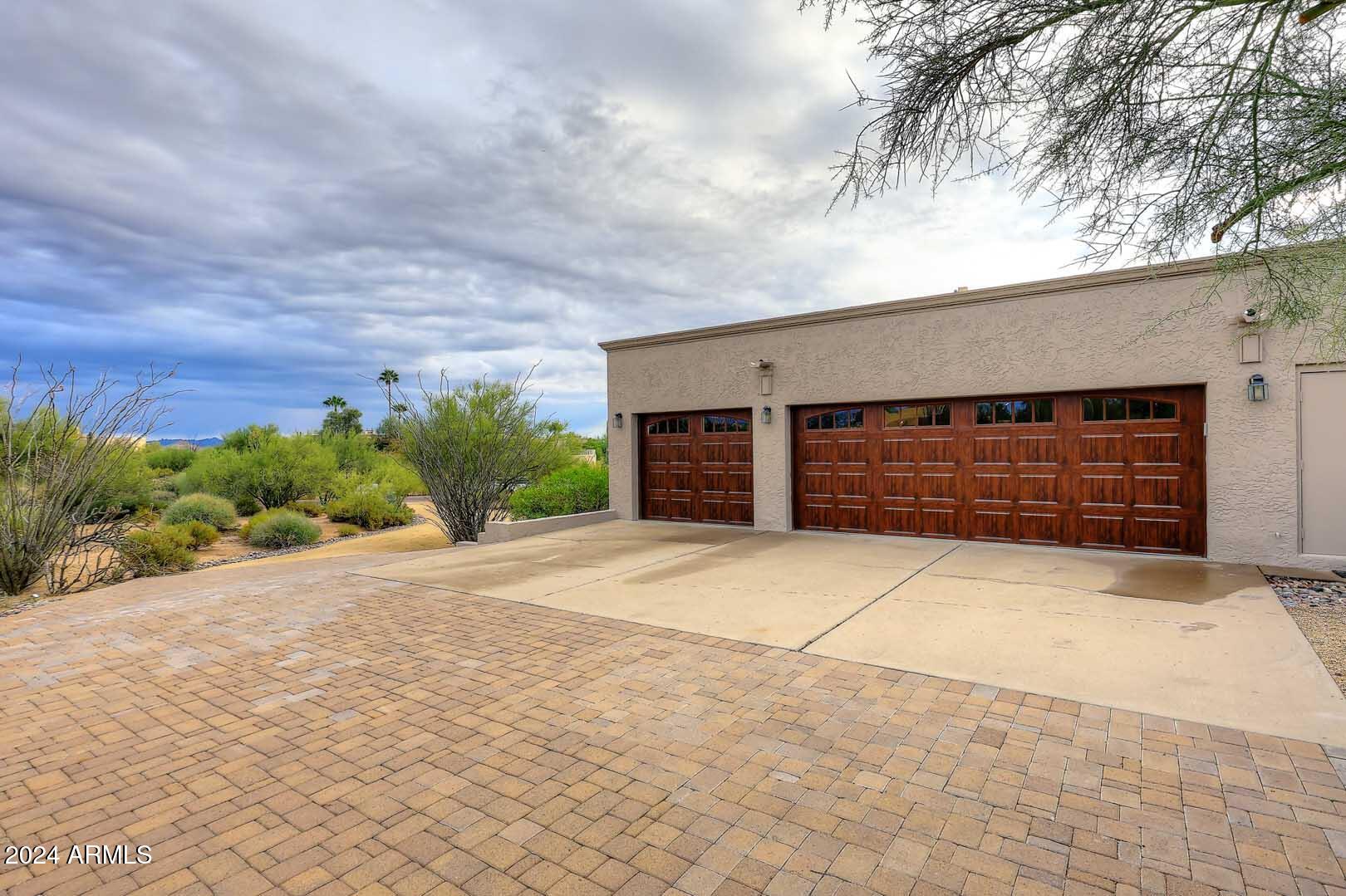 9446 Romping Road Carefree, AZ 85377 - Photo 98 of 119 a front view of a house with a yard and garage