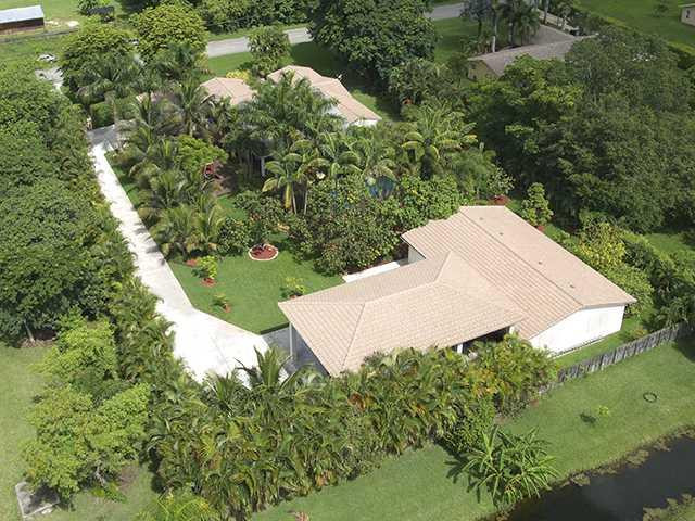 4920 Southwest 166th Avenue Southwest Ranches, FL 33331 - Photo 4 of 23 an aerial view of a house with a yard and lake