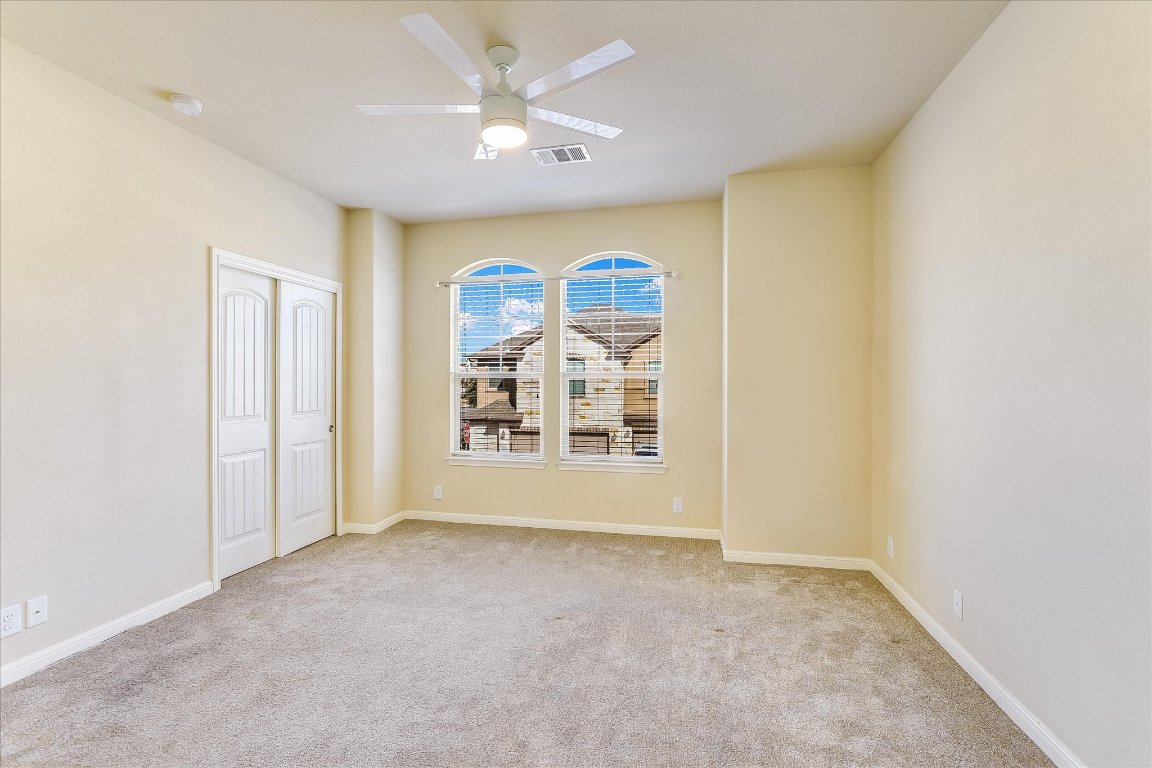 14001 Avery Ranch Boulevard, Unit 2104 Austin, TX 78717 - Photo 17 of 21 an empty room with windows and fan