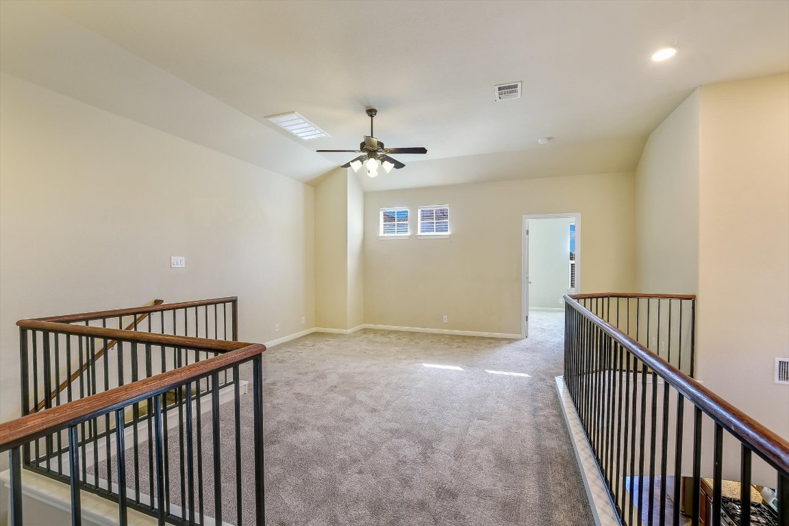 14001 Avery Ranch Boulevard, Unit 2104 Austin, TX 78717 - Photo 8 of 20 a view of a hallway with a ceiling fan