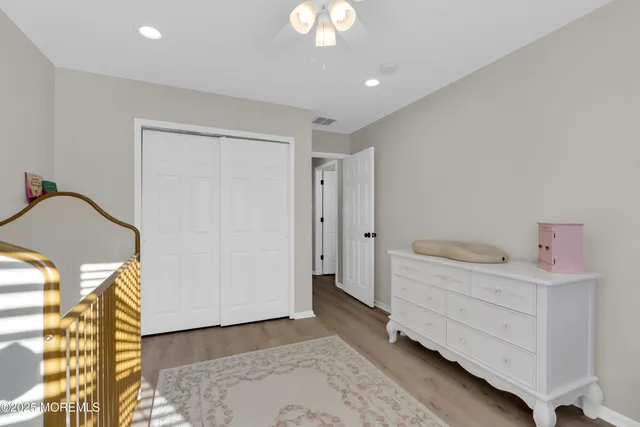 a bathroom with a granite countertop sink a toilet and a mirror