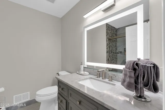 a bedroom with a bed furniture and a flat tv screen