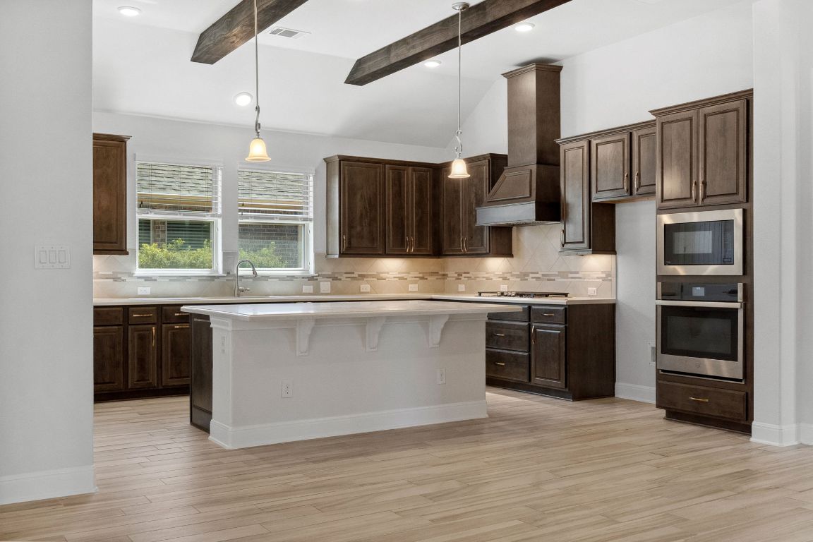 5152 Cornetto Bluffs Round Rock, TX 78665 - Photo 14 of 36 a kitchen with stainless steel appliances granite countertop a refrigerator and a stove top oven