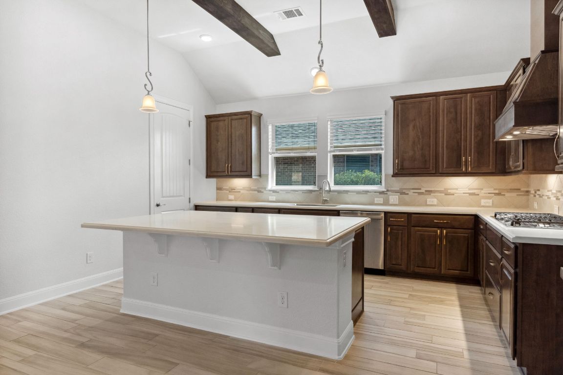 5152 Cornetto Bluffs Round Rock, TX 78665 - Photo 16 of 36 a kitchen with kitchen island granite countertop a sink and a stove top oven