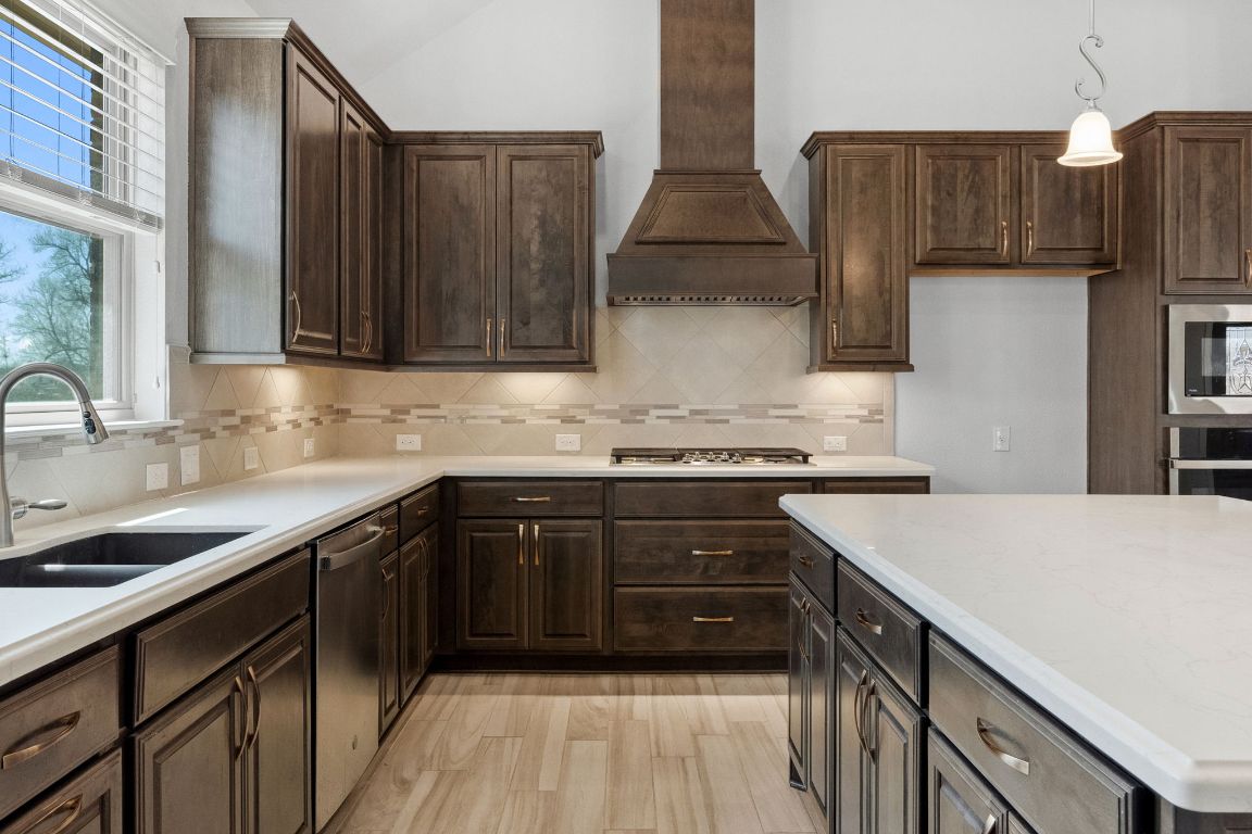 5152 Cornetto Bluffs Round Rock, TX 78665 - Photo 17 of 36 a kitchen with stainless steel appliances granite countertop a sink stove and refrigerator
