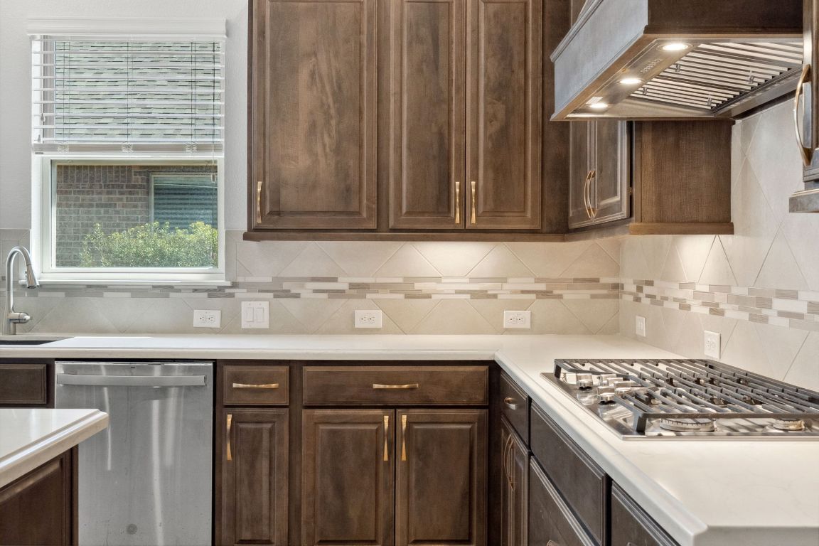 5152 Cornetto Bluffs Round Rock, TX 78665 - Photo 18 of 36 a kitchen with stainless steel appliances granite countertop a sink stove and cabinets