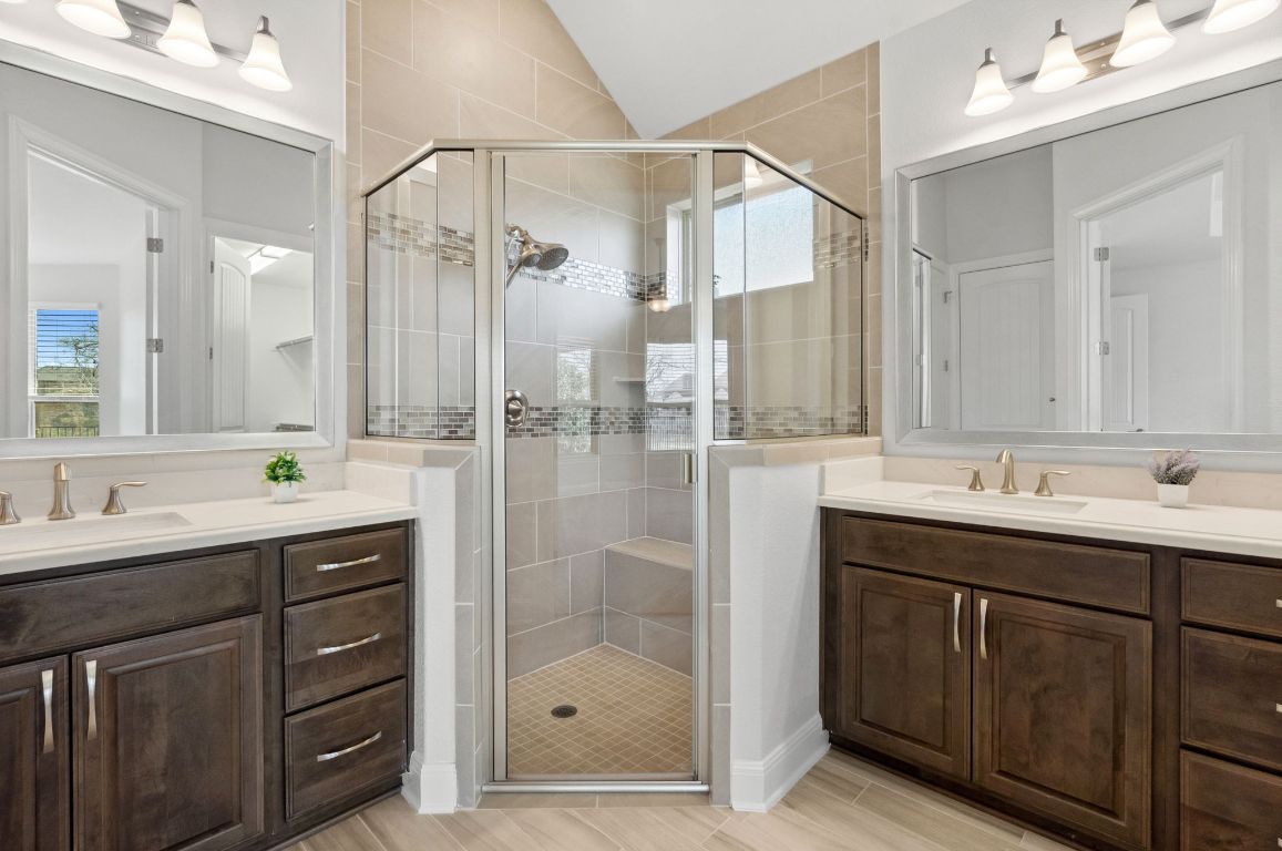 5152 Cornetto Bluffs Round Rock, TX 78665 - Photo 22 of 36 a bathroom with a shower sink double vanity and mirror