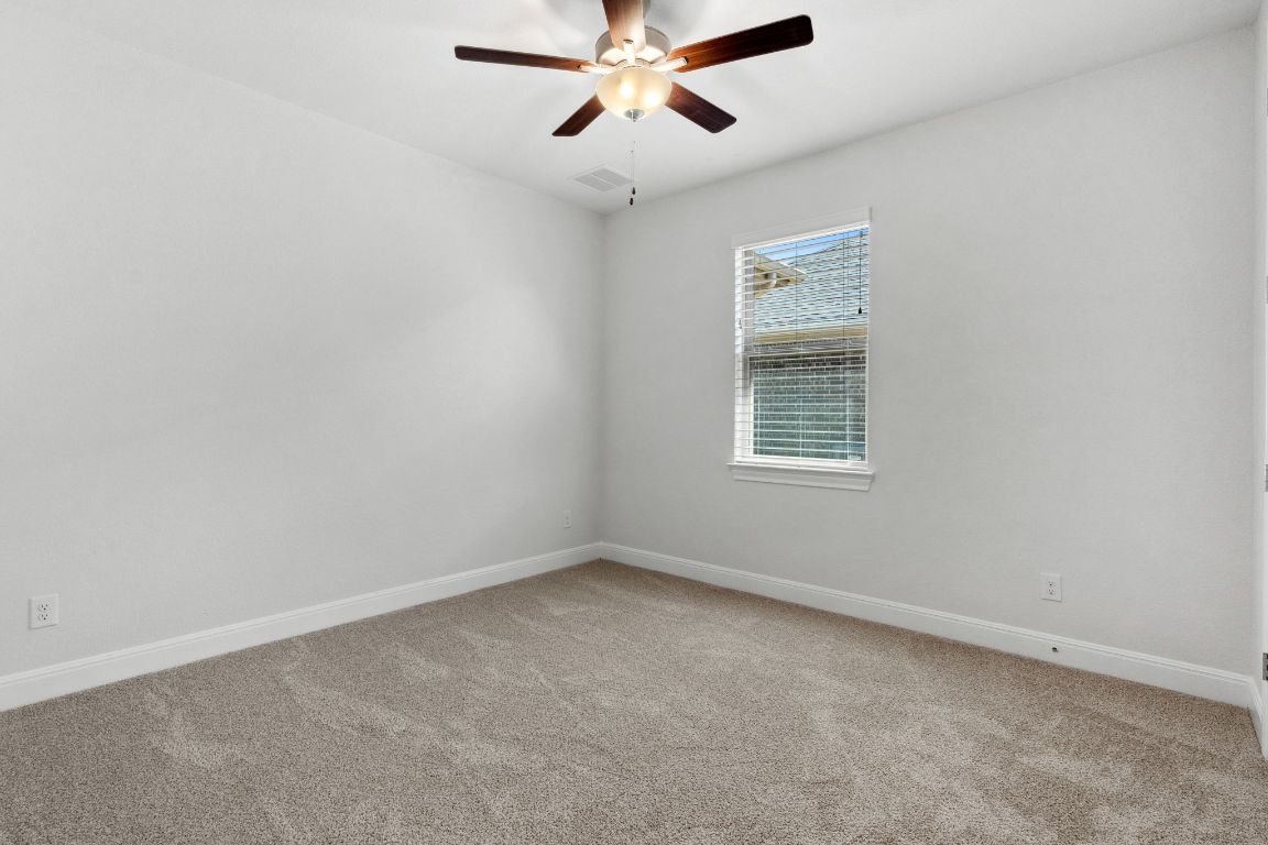 5152 Cornetto Bluffs Round Rock, TX 78665 - Photo 26 of 36 an empty room with a window and a fan