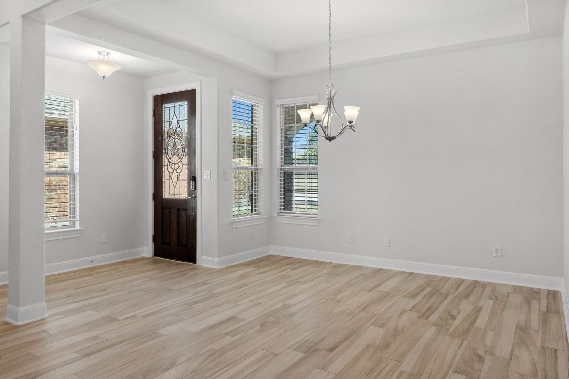 5152 Cornetto Bluffs Round Rock, TX 78665 - Photo 10 of 36 an empty room with wooden floor and windows