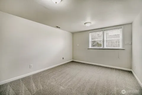 an empty room with a empty space and windows