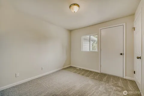a view of an empty room and a window