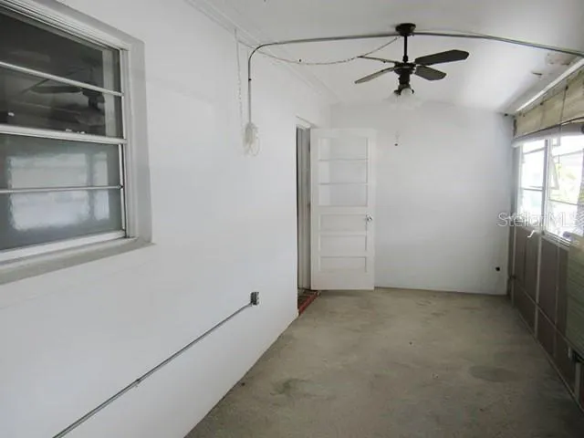 a view of room with window and ceiling fan
