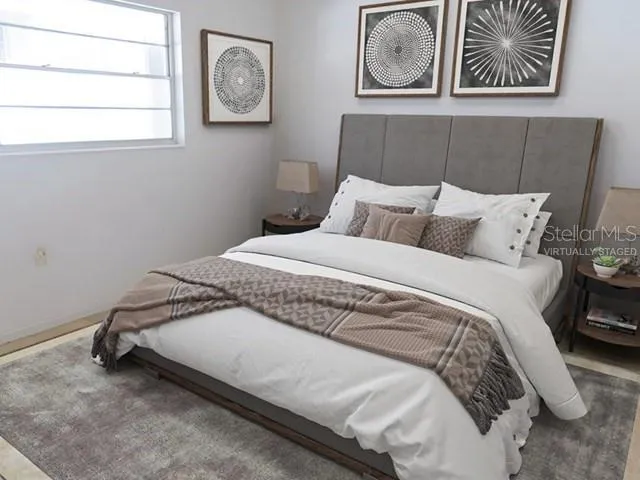 a bedroom with a bed and a window