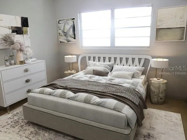 a bedroom with a bed and window