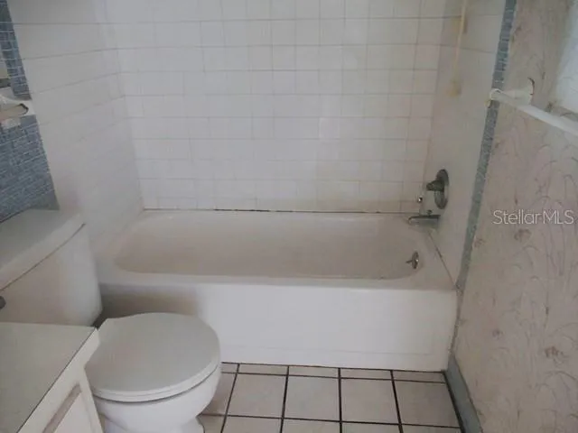 a bathroom with a bathtub and toilet