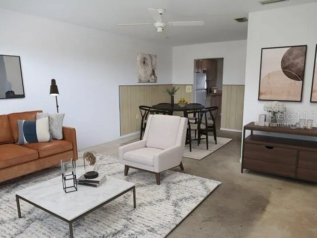 a living room with furniture and wooden floor