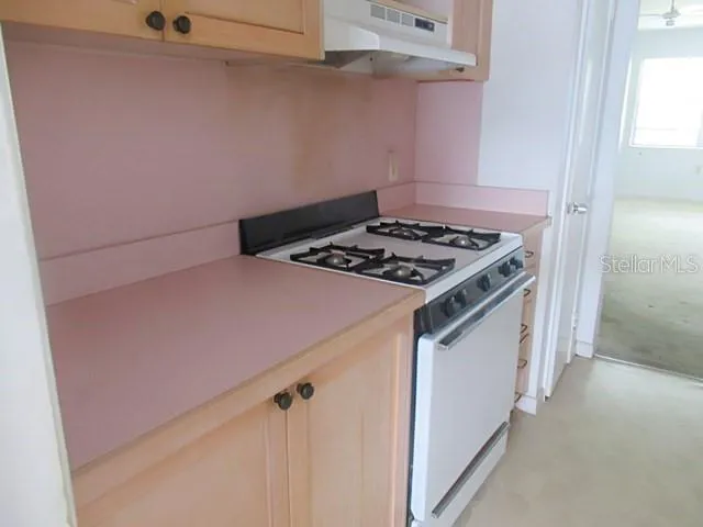a stove top oven sitting inside of a kitchen