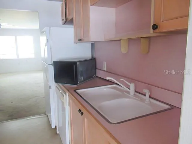 a kitchen with a sink and a refrigerator