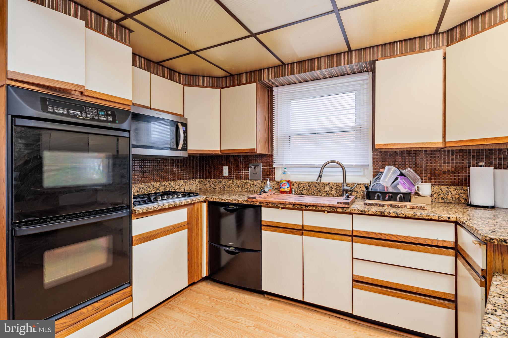 3819 Janbrook Road Randallstown, MD 21133 - Photo 9 of 47 a kitchen with stainless steel appliances granite countertop a sink stove and microwave