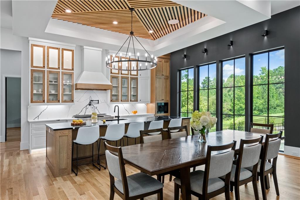 6142 Talmadge Run Acworth, GA 30101 - Photo 26 of 120 a view of a dining room with furniture wooden floor and chandelier