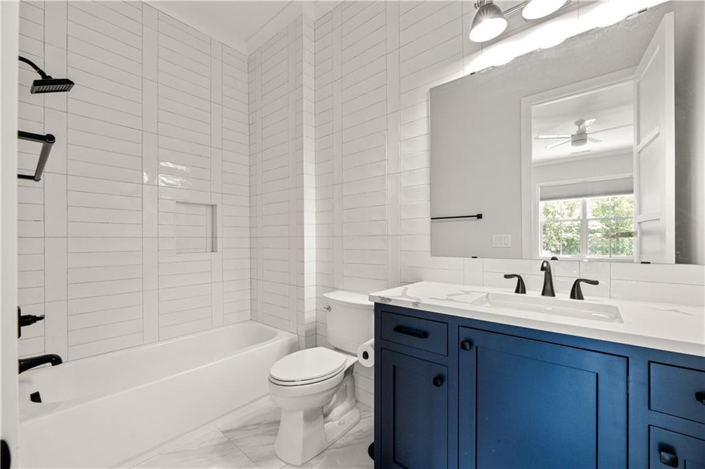 6142 Talmadge Run Acworth, GA 30101 - Photo 59 of 120 a bathroom with a sink a toilet and bathtub