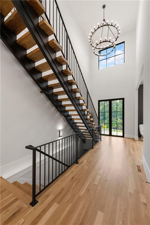 6142 Talmadge Run Acworth, GA 30101 - Photo 8 of 120 a view of staircase with lots of frames on wall and wooden floor